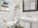 Powder room with pedestal sink, decorative mirror, and charming accents at 310 Medridge Dr, Alpharetta, GA 30022