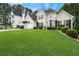Lovely traditional-style home with manicured lawn and mature landscaping at 310 Medridge Dr, Alpharetta, GA 30022