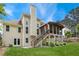Exterior home shot showcasing the expansive backyard, deck, and the architectural details at 310 Medridge Dr, Alpharetta, GA 30022
