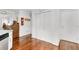 Hallway with hardwood floors, white trim, and closet with paneled doors at 310 Medridge Dr, Alpharetta, GA 30022
