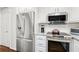 Well-equipped kitchen with stainless steel appliances and granite countertops at 310 Medridge Dr, Alpharetta, GA 30022