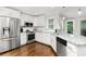 Bright kitchen featuring stainless steel appliances, granite countertops, and hardwood floors at 310 Medridge Dr, Alpharetta, GA 30022