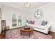 Cozy living room featuring large windows and a comfortable white sofa at 310 Medridge Dr, Alpharetta, GA 30022