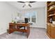 Bright home office features a wooden desk, modern computer, and natural light at 310 Medridge Dr, Alpharetta, GA 30022