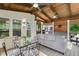 Comfortable screened porch featuring wood ceiling, ceiling fans, and a cozy seating area for relaxation at 310 Medridge Dr, Alpharetta, GA 30022