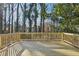 Spacious wooden deck overlooking a private, tree-lined backyard, perfect for outdoor relaxation at 1120 Starline Se Dr, Smyrna, GA 30080