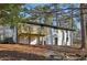 Back exterior view of the house showing the deck and expansive yard space with mature trees at 1120 Starline Se Dr, Smyrna, GA 30080