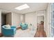 Cozy seating area with stylish turquoise chairs, soft rug, and ample natural light from nearby doorway at 1120 Starline Se Dr, Smyrna, GA 30080