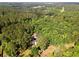 Birds eye view of the home and surrounding wooded acreage at 1143 Mcgarity Rd, Mcdonough, GA 30252