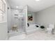 Modern bathroom featuring a glass-enclosed shower, soaking tub, and sleek tile at 1143 Mcgarity Rd, Mcdonough, GA 30252