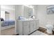 An efficiently designed bathroom includes a vanity and cabinet with an adjoining bedroom at 1143 Mcgarity Rd, Mcdonough, GA 30252