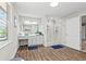 A well-lit bathroom boasts wood-look tile flooring and a glass enclosed shower with modern fixtures at 1143 Mcgarity Rd, Mcdonough, GA 30252