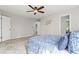 A bright, neutrally decorated bedroom offers a cozy retreat with soft carpet and a ceiling fan at 1143 Mcgarity Rd, Mcdonough, GA 30252