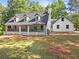 Charming white home with covered front porch, dark shutters, and freshly cut lawn exudes curb appeal at 1143 Mcgarity Rd, Mcdonough, GA 30252