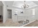 Upstairs hallway with an elegant chandelier, carpet flooring, and stylish railing at 1143 Mcgarity Rd, Mcdonough, GA 30252