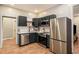 Modern kitchen with stainless steel appliances, dark cabinetry and sleek countertops at 1336 Mcclelland Ave, Atlanta, GA 30344