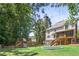 Spacious backyard with a playset, trampoline, and lush greenery, perfect for outdoor activities and relaxation at 2567 Briers North Dr, Dunwoody, GA 30360