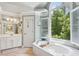 Luxurious bathroom with soaking tub, double vanity, and large window at 2567 Briers North Dr, Dunwoody, GA 30360