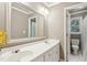 Bright bathroom featuring a dual sink vanity with a large mirror and a separate toilet and shower room at 2567 Briers North Dr, Dunwoody, GA 30360