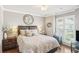 Cozy bedroom with a decorative tree art piece, a comfortable bed, and natural light coming through the plantation shutters at 2567 Briers North Dr, Dunwoody, GA 30360