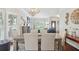 Elegant dining room with hardwood floors, stylish chandelier, and views into the living room at 2567 Briers North Dr, Dunwoody, GA 30360