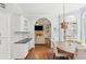 Inviting dining area with hardwood floors, built-in cabinets, and a view into the cozy living room at 2567 Briers North Dr, Dunwoody, GA 30360