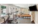 Bright exercise room with a large mirror, gym equipment, and windows for natural light and backyard views at 2567 Briers North Dr, Dunwoody, GA 30360