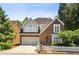 Charming two-story brick home with a manicured lawn, white picket fence and attached two-car garage at 2567 Briers North Dr, Dunwoody, GA 30360