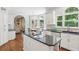 Modern kitchen with white cabinets, stainless steel appliances, granite countertops and hardwood floors at 2567 Briers North Dr, Dunwoody, GA 30360