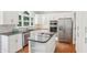 Well-appointed kitchen featuring white cabinets, stainless steel appliances, granite countertops, and island at 2567 Briers North Dr, Dunwoody, GA 30360