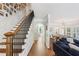 Spacious living room with hardwood floors, staircase, fireplace, and arched doorway into dining room at 2567 Briers North Dr, Dunwoody, GA 30360