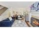 Cozy living room featuring a fireplace, hardwood floors, and a view of the adjacent dining area at 2567 Briers North Dr, Dunwoody, GA 30360