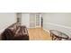 Basement living room with hardwood floors, brown leather sofa, and glass door to a walk-in closet at 2567 Briers North Dr, Dunwoody, GA 30360