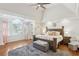 Spacious main bedroom with tray ceiling, large windows, and hardwood floors at 2567 Briers North Dr, Dunwoody, GA 30360