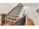Elegant staircase with wooden handrail and iron balusters at 2567 Briers North Dr, Dunwoody, GA 30360