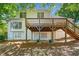 Beautiful backyard featuring a spacious wooden deck, a covered patio, and verdant landscaping at 2682 Varner Dr, Atlanta, GA 30345