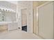 Traditional bathroom with wallpaper, white tile floors, glass shower doors, and dual vanities at 2682 Varner Dr, Atlanta, GA 30345