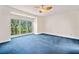 Bright bedroom featuring a ceiling fan, a large window and comfortable blue carpeting at 2682 Varner Dr, Atlanta, GA 30345