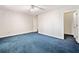 Bedroom with neutral paint, blue carpet, ceiling fan, and access to closet or ensuite at 2682 Varner Dr, Atlanta, GA 30345