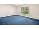 Neutral bedroom featuring one window and blue carpet, ideal for restful relaxation at 2682 Varner Dr, Atlanta, GA 30345