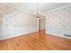 Formal dining room featuring hardwood floors, elegant wallpaper, and classic wainscoting at 2682 Varner Dr, Atlanta, GA 30345