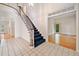 Grand foyer with stairs featuring blue carpet and leading to an open floor plan with hardwood floors at 2682 Varner Dr, Atlanta, GA 30345