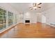 Spacious living room featuring hardwood floors, a fireplace, and large windows with scenic views at 2682 Varner Dr, Atlanta, GA 30345