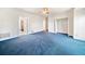 Spacious main bedroom with blue carpet, ceiling fan and doorways leading to a walk-in closet at 2682 Varner Dr, Atlanta, GA 30345