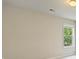 Minimalist bedroom with neutral walls, a large window, and plush carpet flooring at 4650 Pleasant Woods Dr, Cumming, GA 30028
