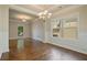 Dining room featuring hardwood floors, elegant chandelier, and classic wainscoting at 4650 Pleasant Woods Dr, Cumming, GA 30028