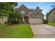 Charming two-story brick home featuring a well-manicured lawn and a two-car garage at 4650 Pleasant Woods Dr, Cumming, GA 30028