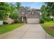 Charming two-story brick home featuring a well-manicured lawn and a two-car garage at 4650 Pleasant Woods Dr, Cumming, GA 30028