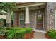 Inviting front porch with brick facade, decorative shutters, and well-maintained landscaping at 4650 Pleasant Woods Dr, Cumming, GA 30028