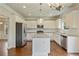 Modern kitchen featuring white cabinetry, granite countertops, and a kitchen island at 4650 Pleasant Woods Dr, Cumming, GA 30028